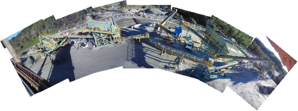 An aerial view of a construction site featuring crushing and screening plants.