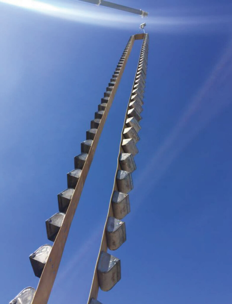 A metal ladder with a blue sky in the background.