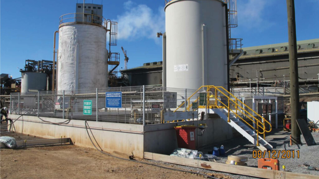 A sprawling industrial plant featuring multiple tanks and efficiently operated by advanced belt conveyors.