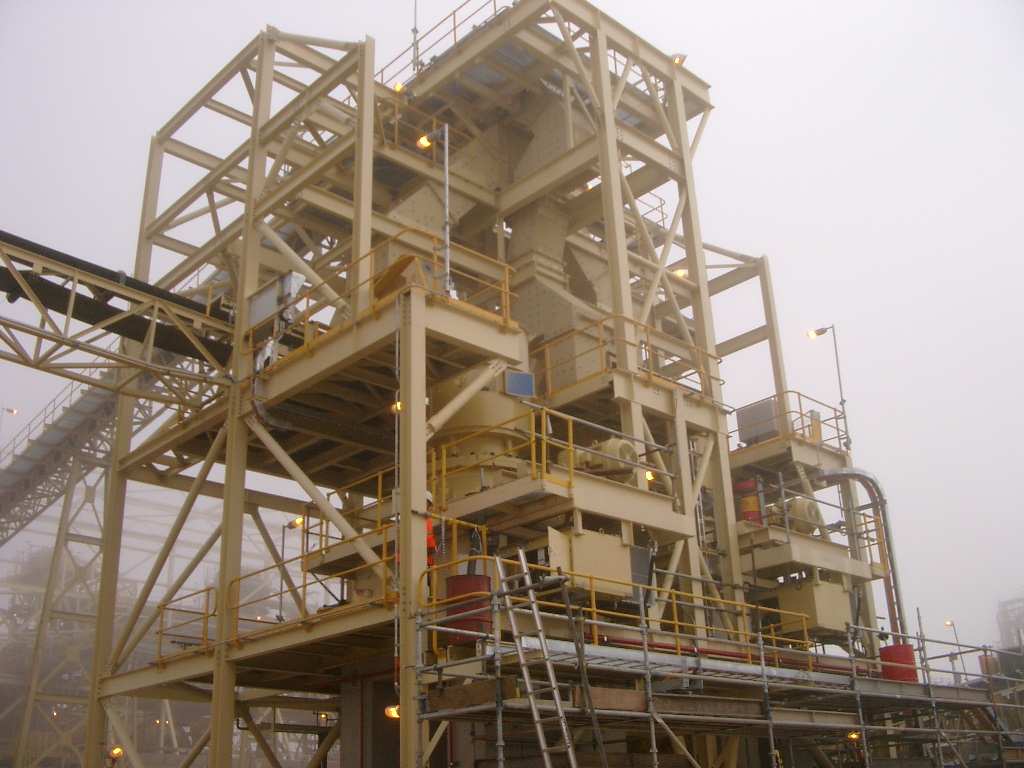 A large industrial plant equipped with belt conveyors and various machinery.