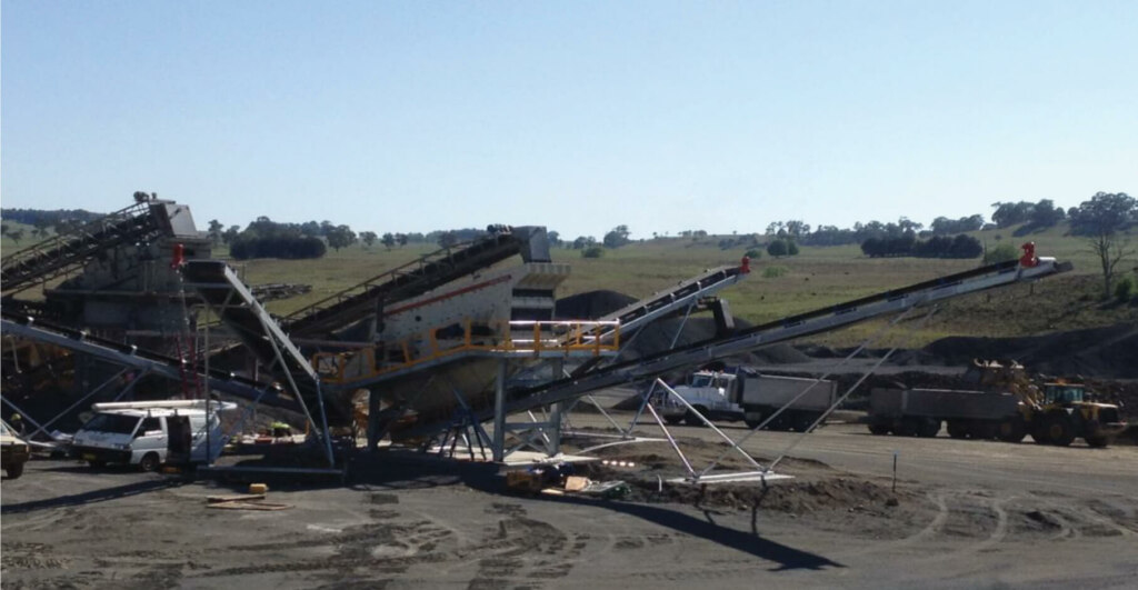 A construction site with a conveyor belt in the background, showcasing a product being transported on the module screen.