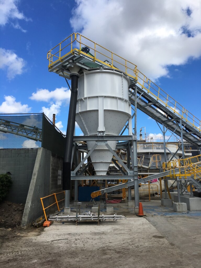 A large cement plant with a ball mill circuit in front of it.