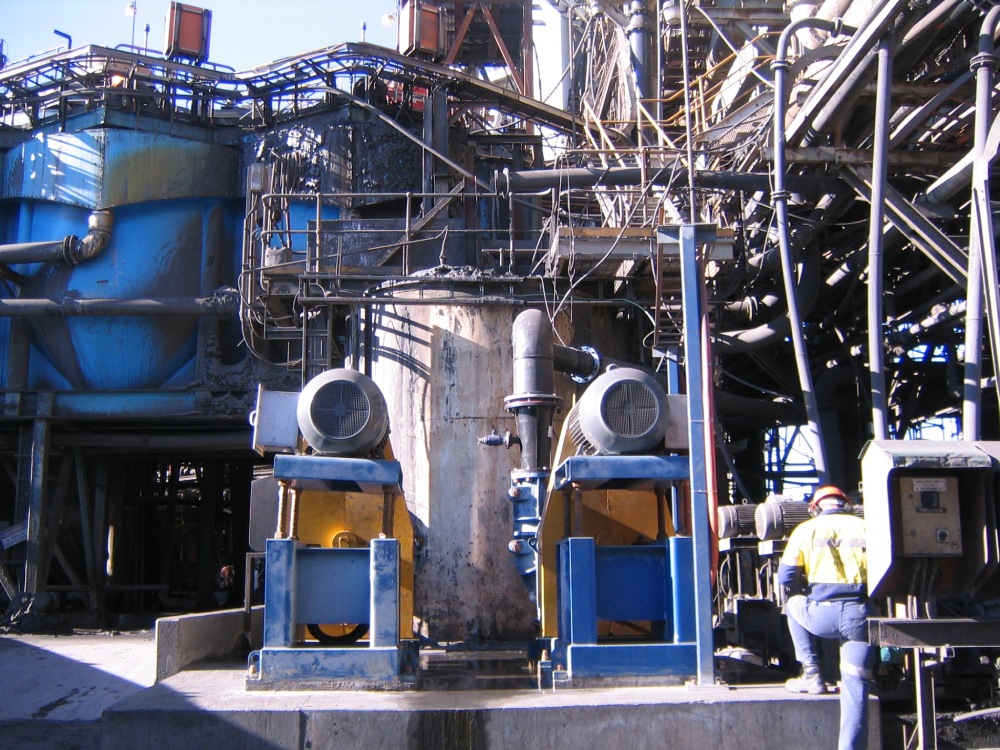 A man stands in front of a large metal structure equipped with an upgraded pump system for improved floatation.