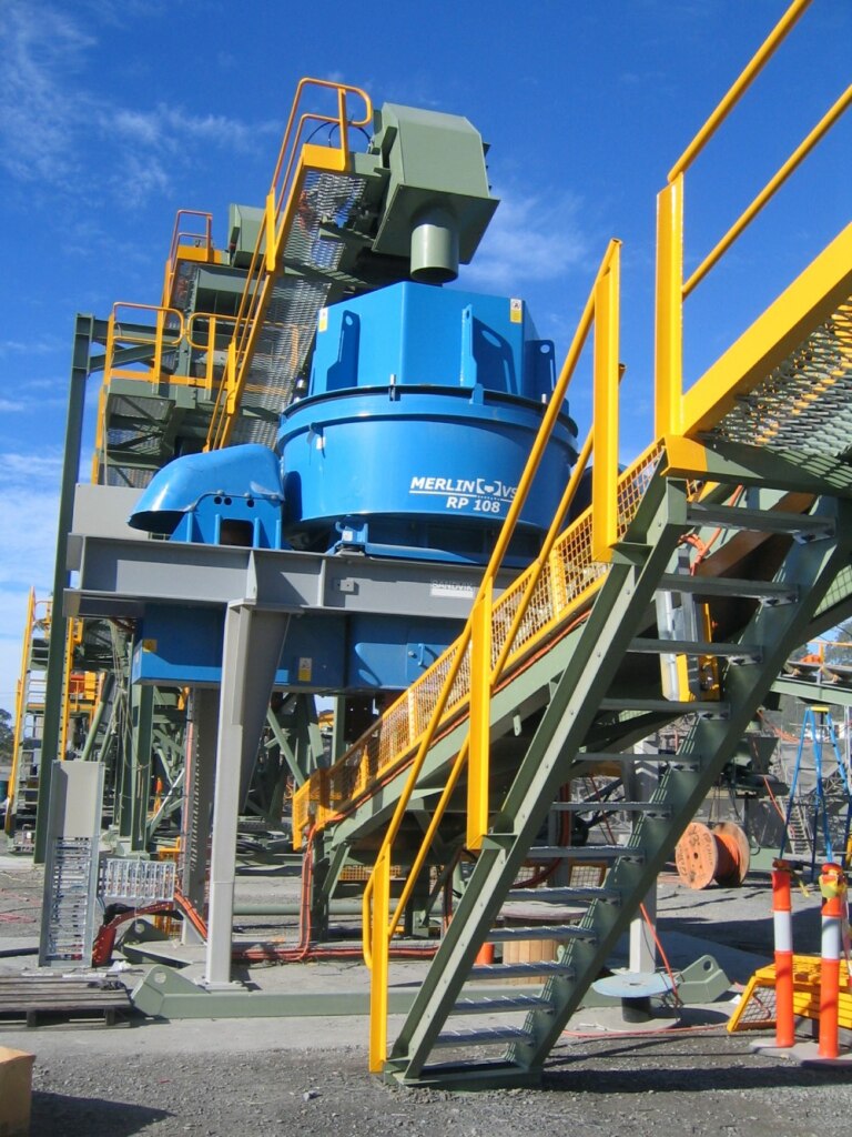 A blue and yellow crushing machine.