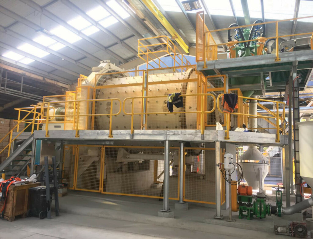 A large factory equipped with a vast array of machines, including belt conveyors.