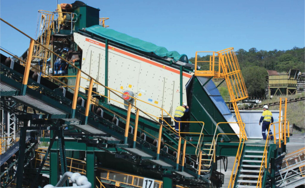 A Belt conveyor with people working on it.