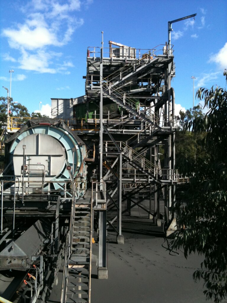 A large metal belt conveyor structure.