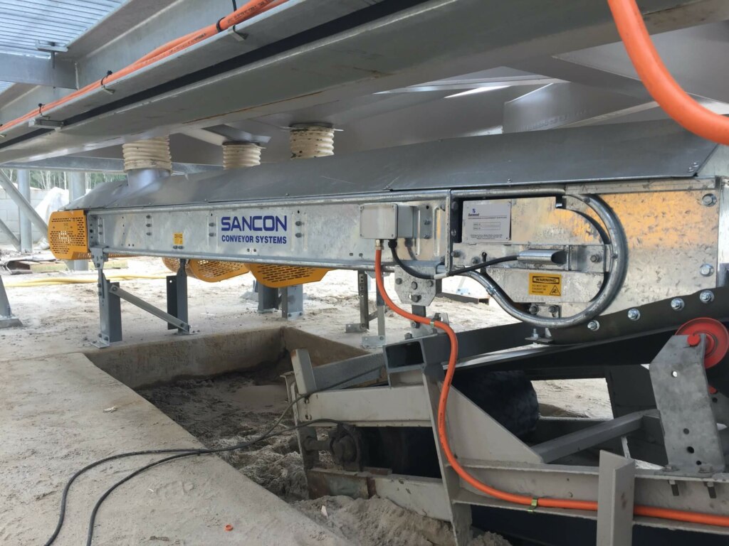 A truck loadout facility is utilizing a conveyor belt for construction purposes.