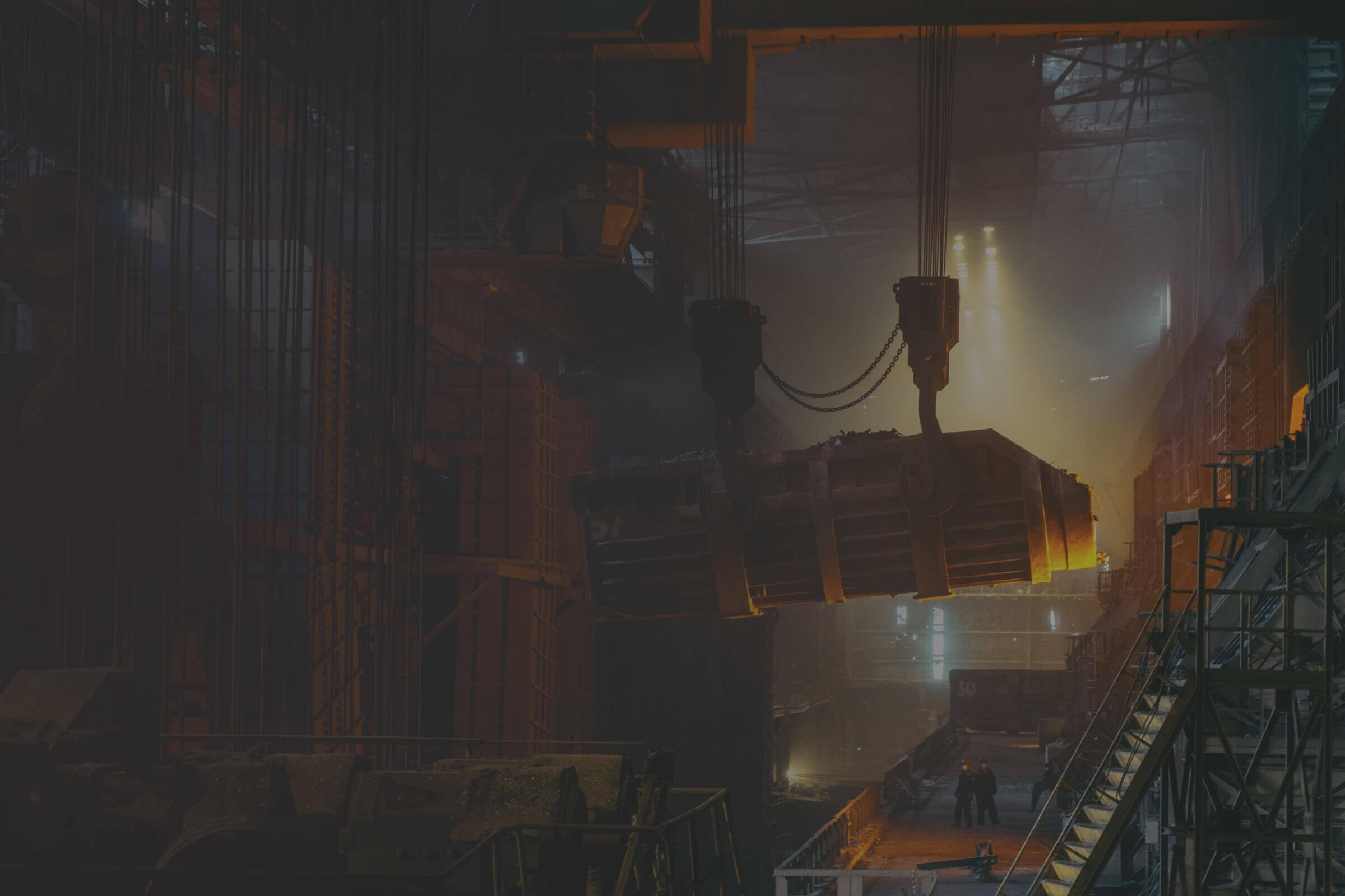 A dark industrial scene with a crane in the background.